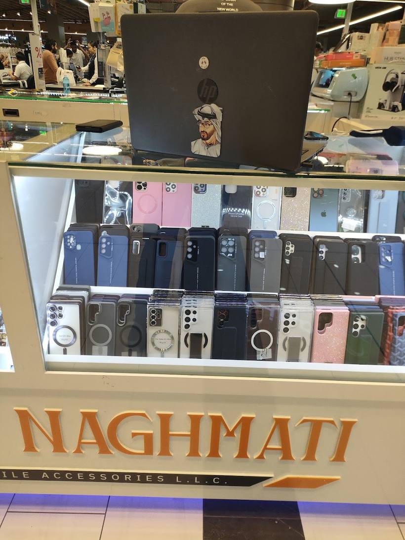 Rows of phone cases in clear, black, grey and pink under the NAGHMATI sign