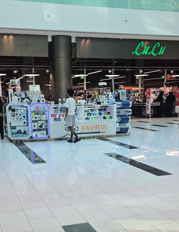 The Naghmati kiosk on the shiny mall floor, with the LuLu sign behind it